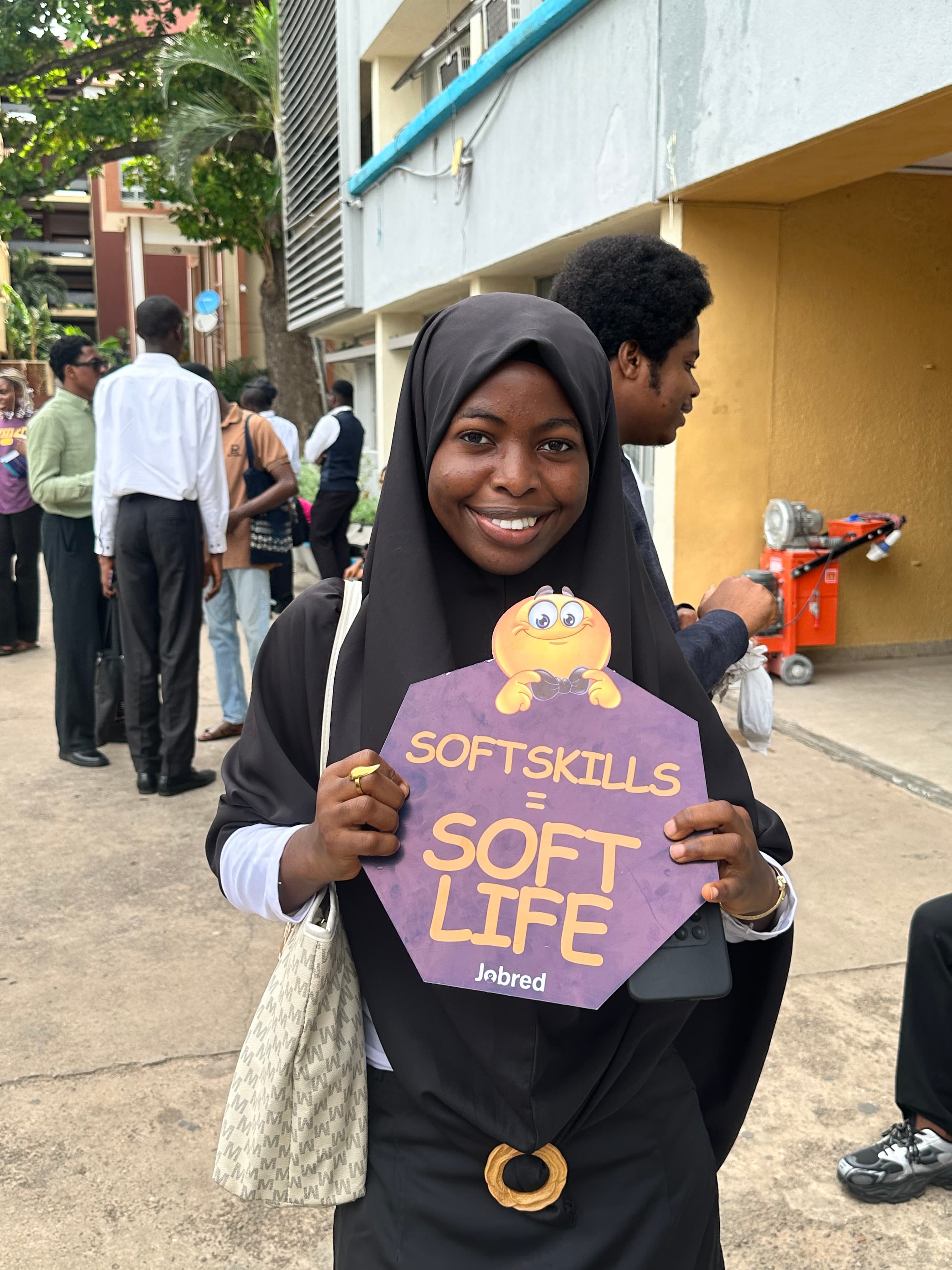 A JobRed participant holding a soft skills placard